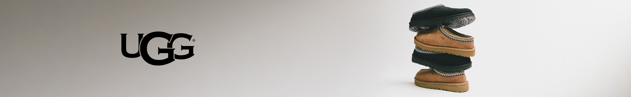 simple white desk on a white wall with a plant on the far right side