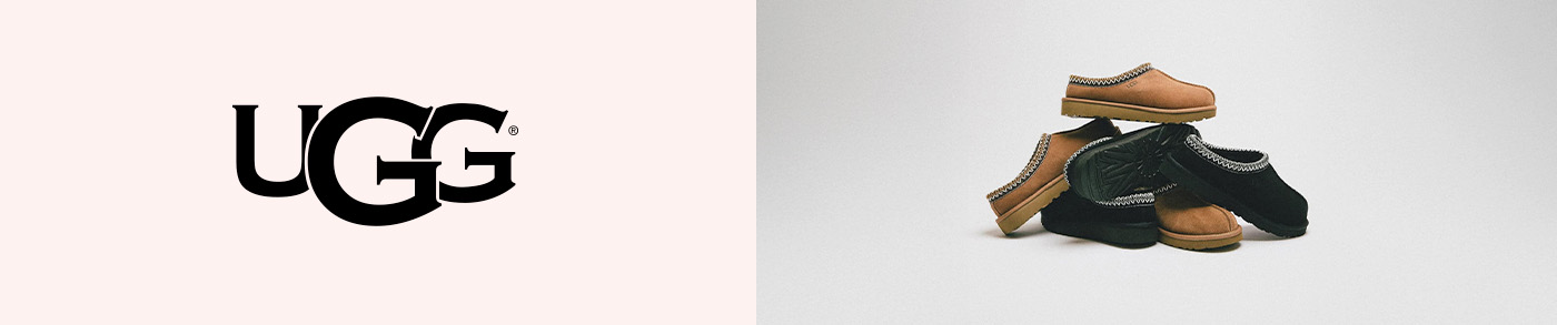 simple white desk on a white wall with a plant on the far right side