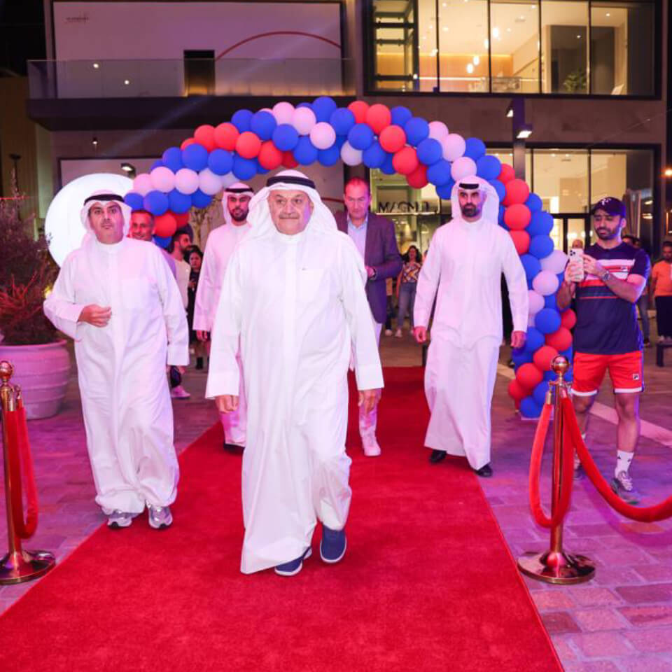 Desert cleanup volunteers in purple shirts walking across desert terrain