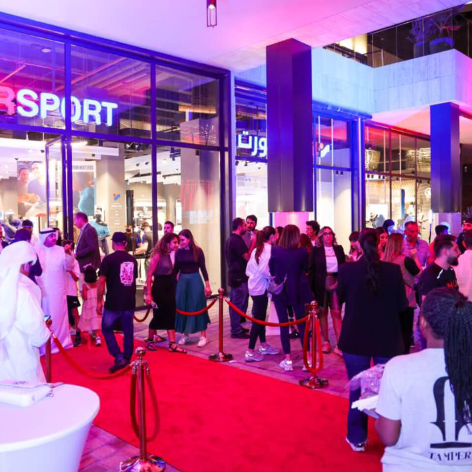 Intersport sponsored cleanup station with volunteers organizing collected waste