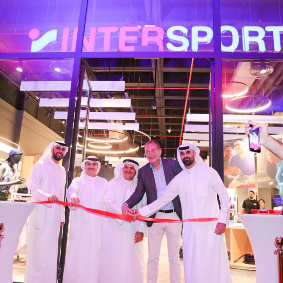 Volunteers in purple shirts carrying large bags of collected desert waste