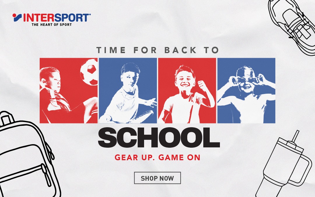 simple white desk on a white wall with a plant on the far right side